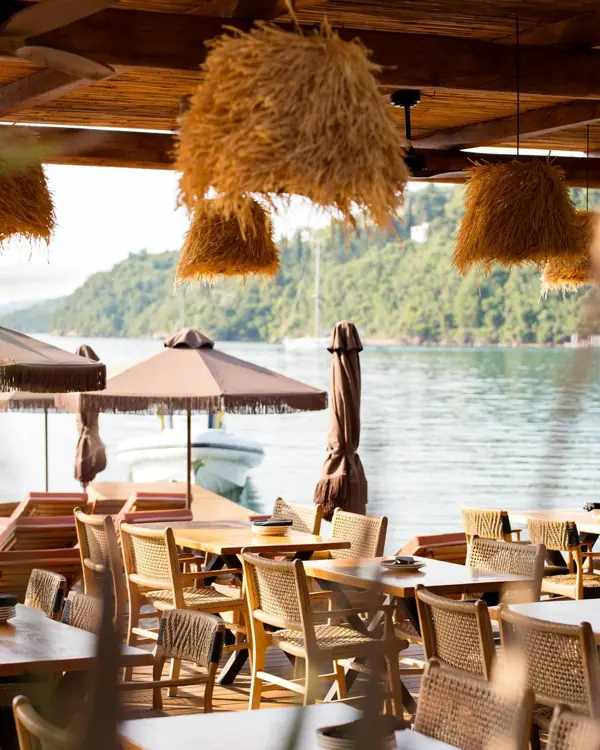 Taverna terrace with wicker chairs by the sea