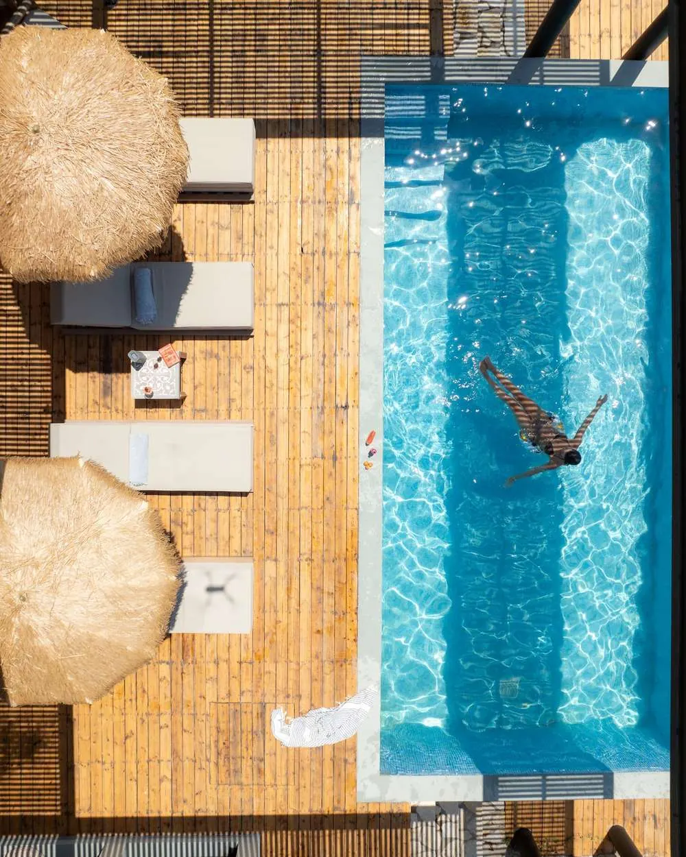 Drone view of a villa pool with sun loungers